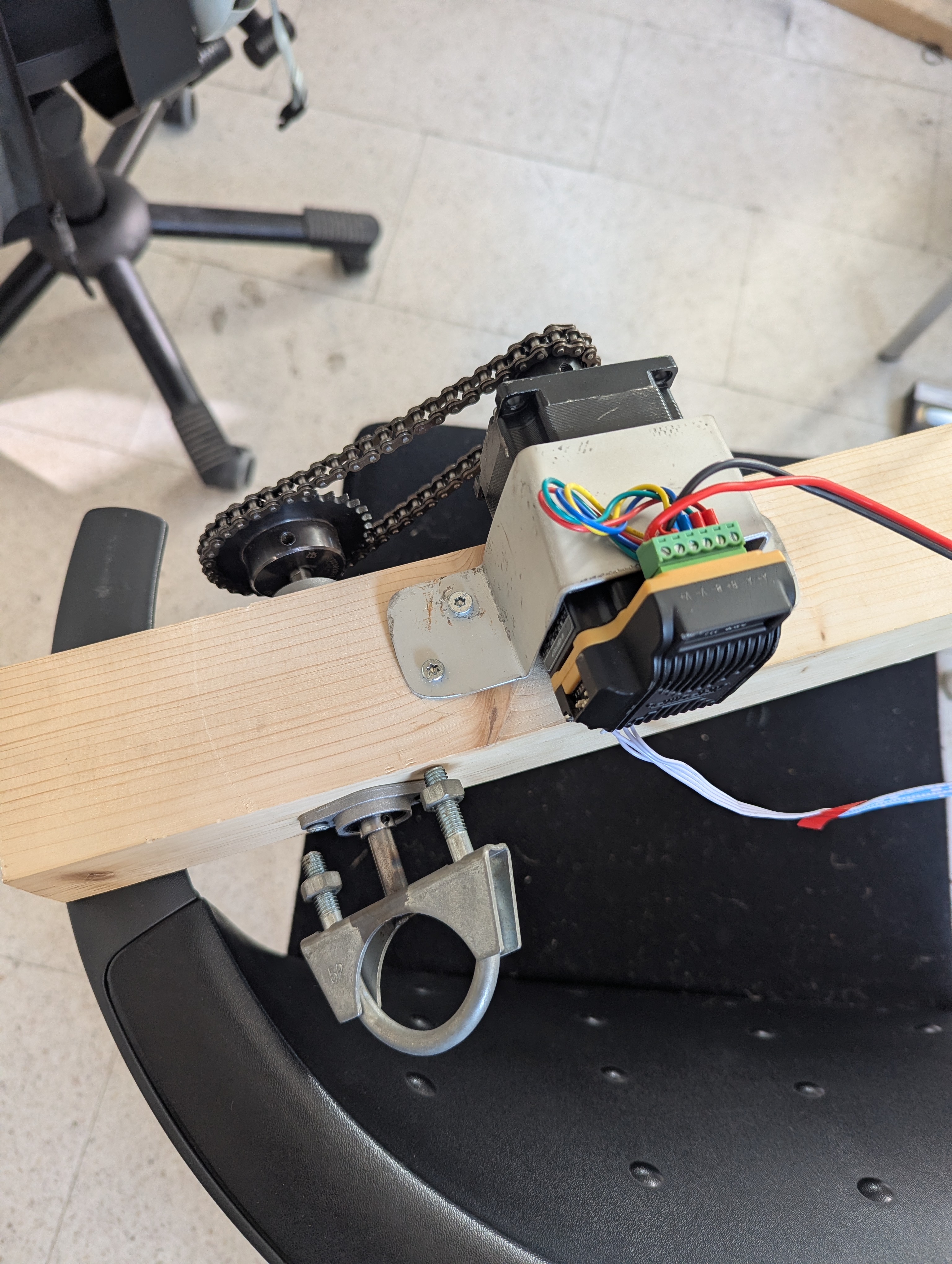 The drive mechanism of Rain Reminders: NEMA 23 stepper motor, gear and chain, wood beam, metal frame. The object shows you exactly what it is and how it works.